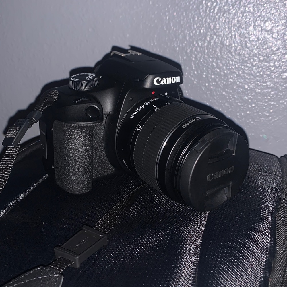 Selling a Canon Rebel T100 Camera with a lot of accessories and a backpack.